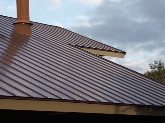 Brown Metal Roof With a Chimney on Top of It — CP Roofing in Old Bar, NSW