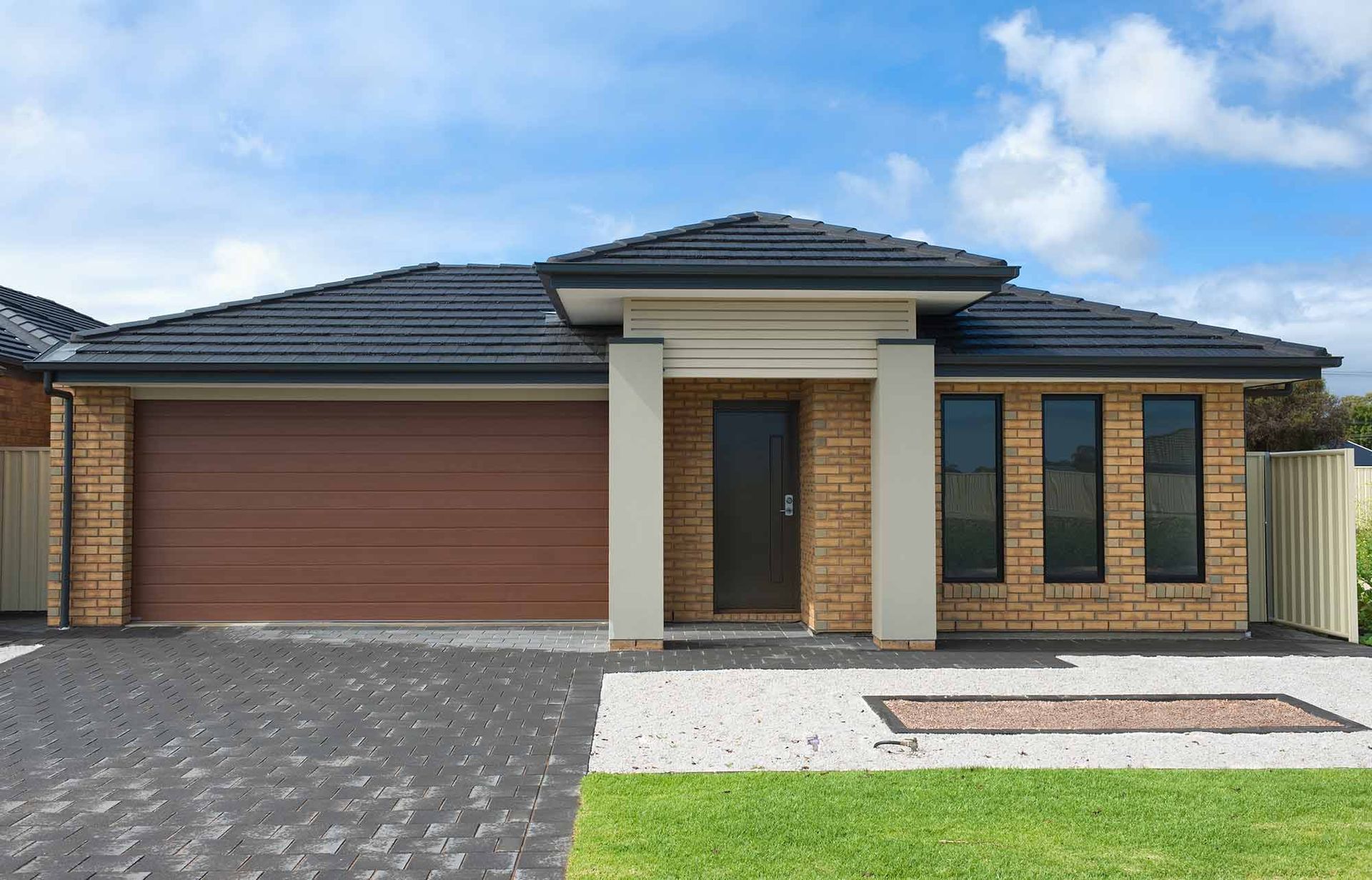 Brick House With a Garage and a Driveway — CP Roofing in Harrington, NSW