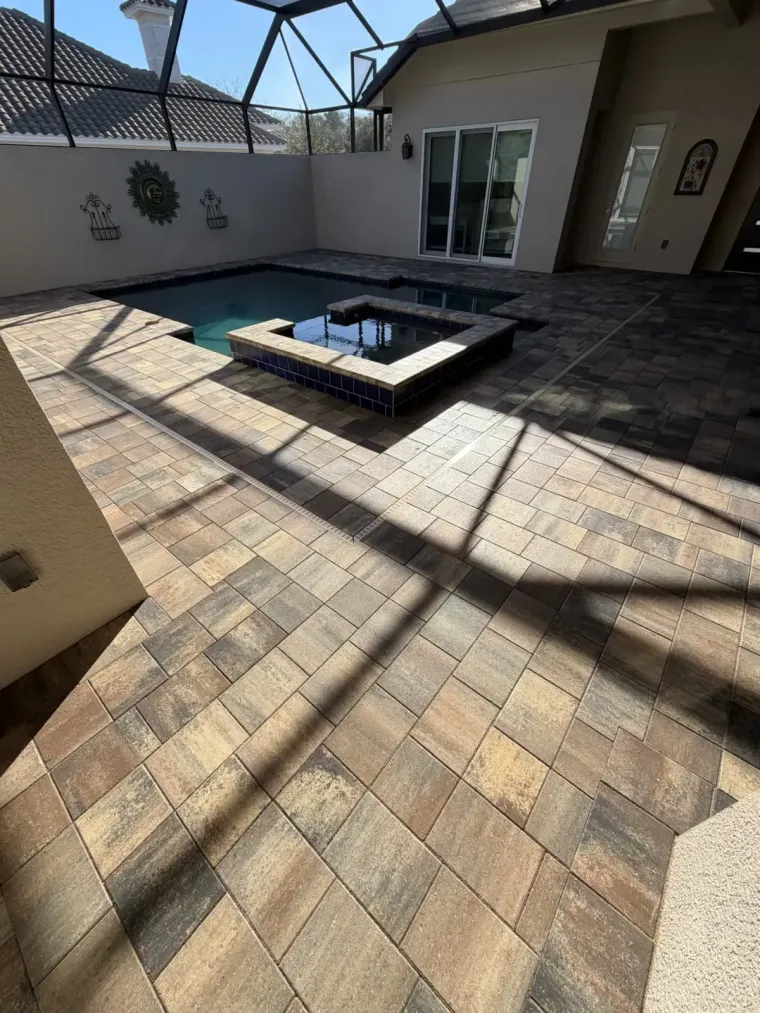 Read more about our pressure washing services An arched stone entryway with a pristine pressure washed paved driveway at sunset in Palm Coast, Flagler County, FL.
