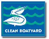 Clean Boatyard sign with a white pelican over blue waves on a blue background.