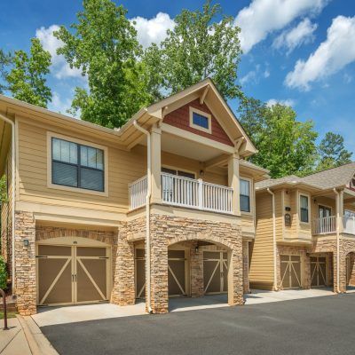 A large house with a balcony and garage doors