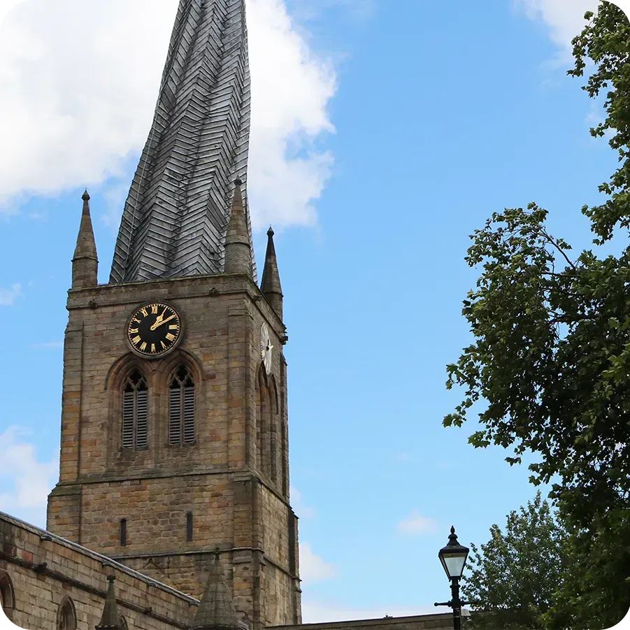 The Crooked Spire church in Chesterfield surrounded by pink flowers