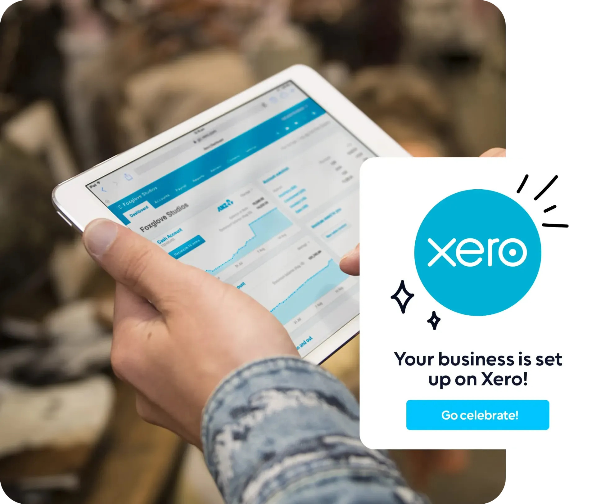 A business owner holding a tablet featuring the Xero software.