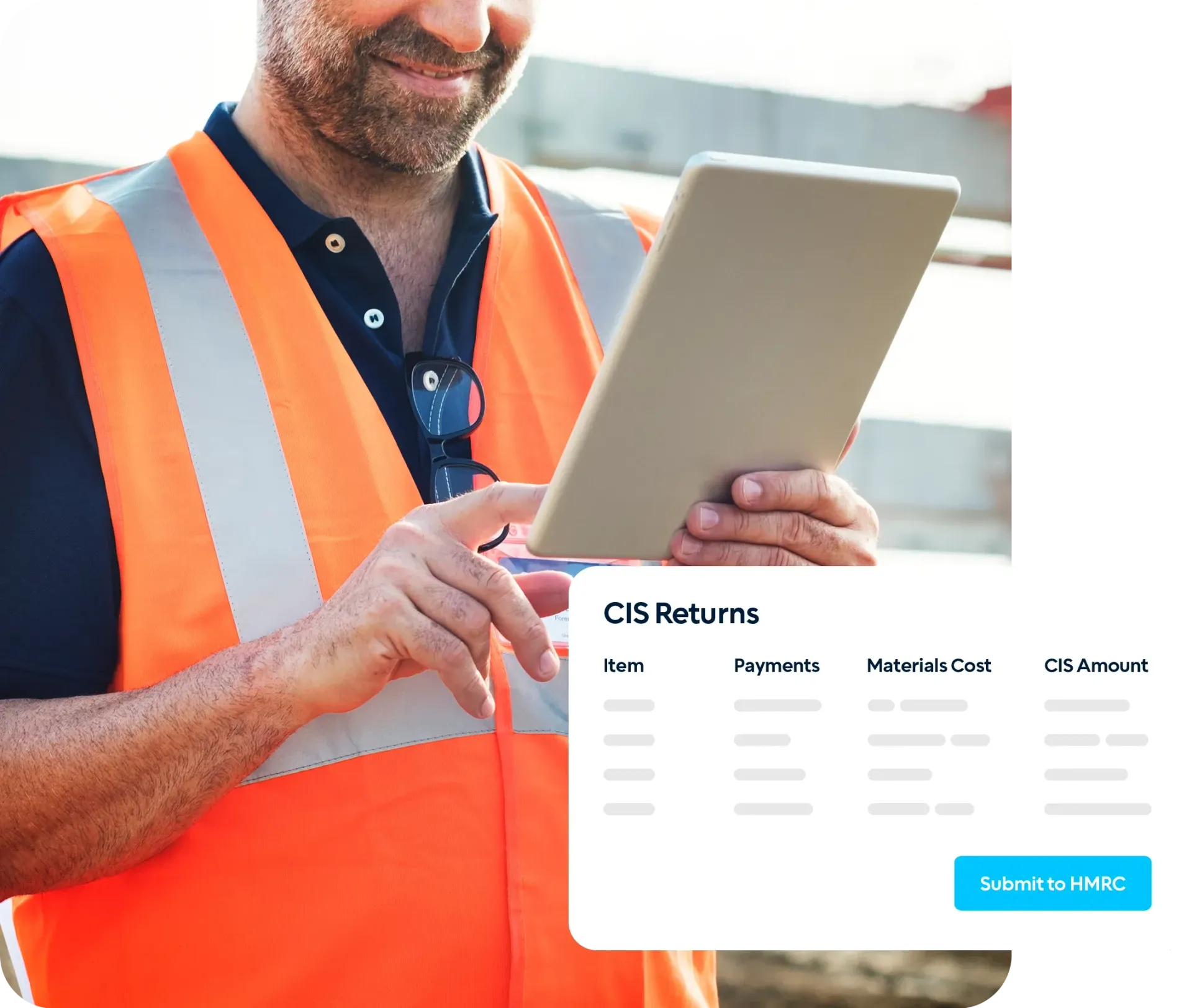 A construction worker on-site holding a tablet.