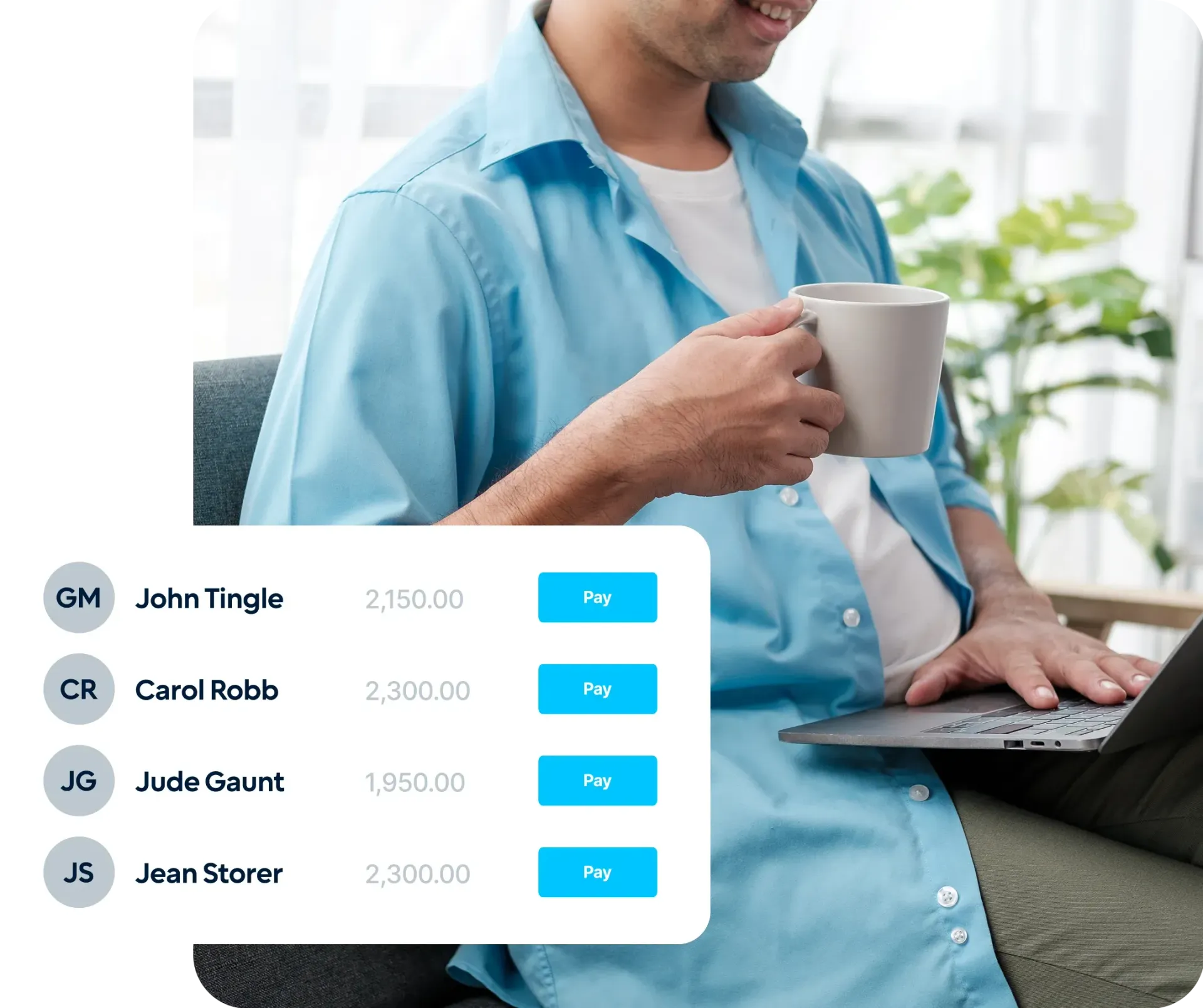 A man is holding a cup of coffee while using a laptop