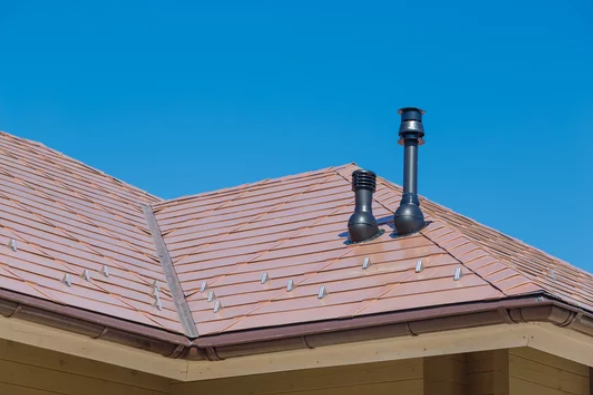 A copper roof showcasing its vibrant reddish-brown patina and textured surface.