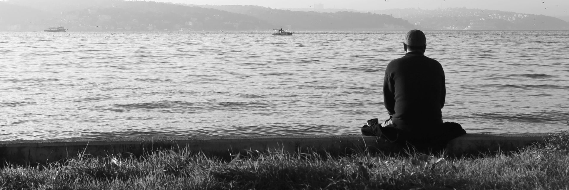 A man sitting at the ocean.