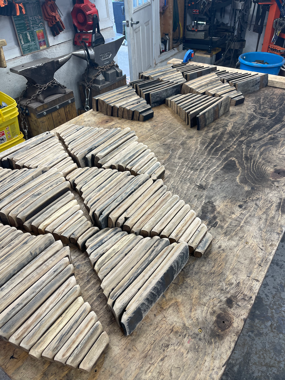 A bunch of wooden sticks are sitting on top of a wooden table.