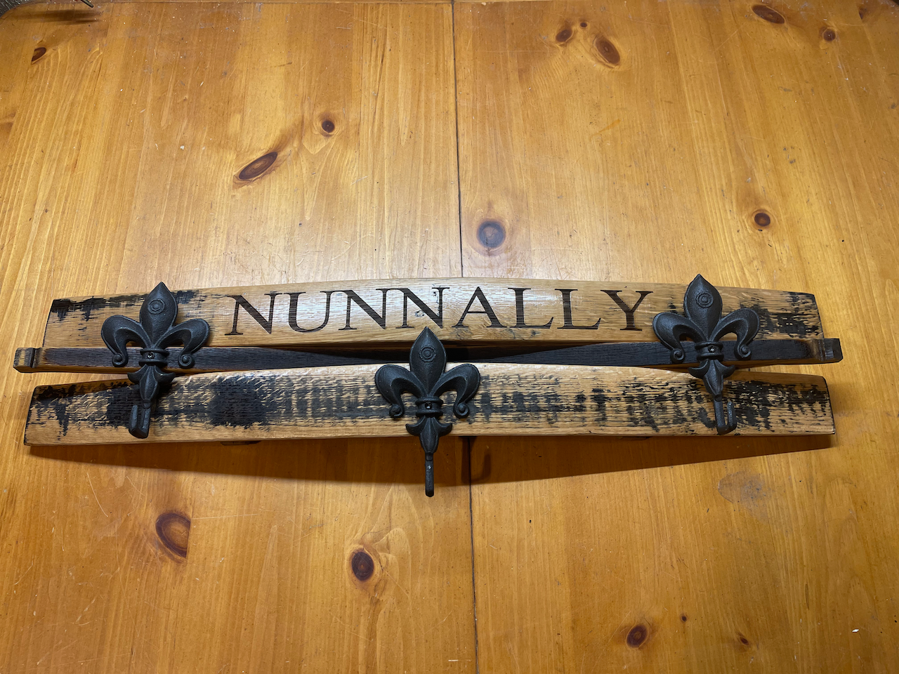 A wooden sign that says nunnally is sitting on a wooden table.