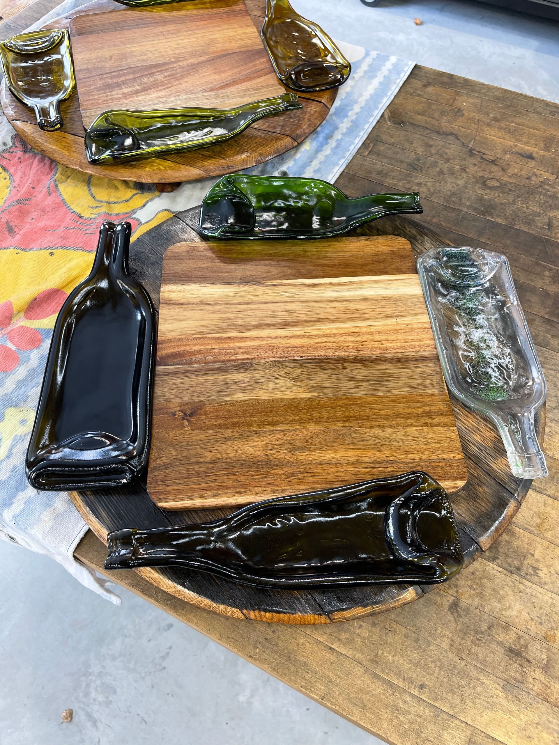 A wooden cutting board with a bottle on top of it.