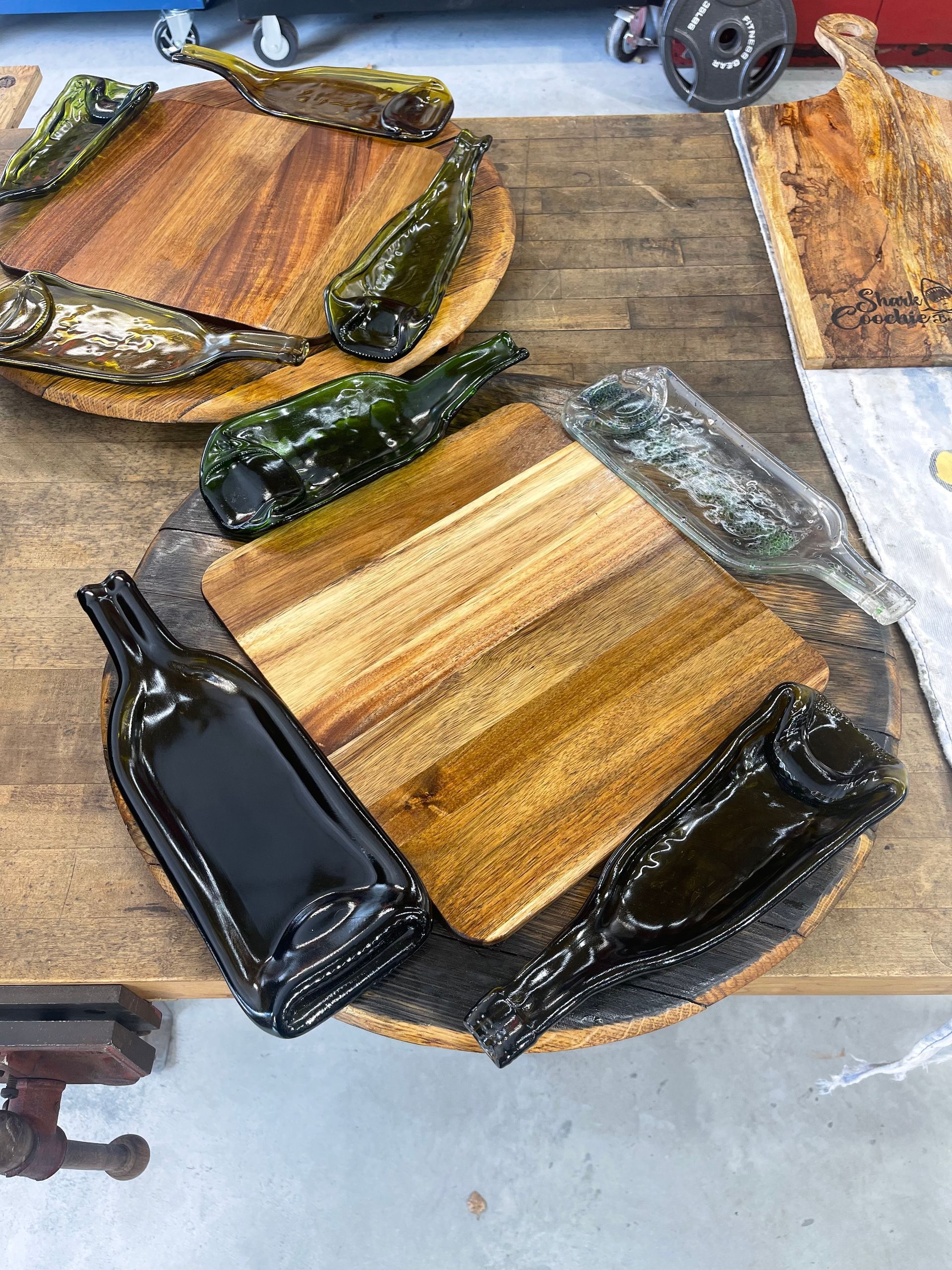A wooden cutting board with a bottle of wine on it.