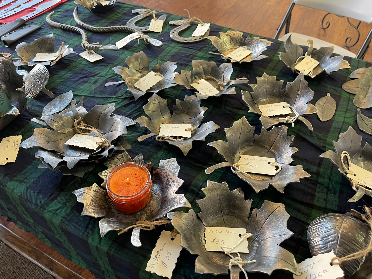 A table with a lot of plates and a candle on it