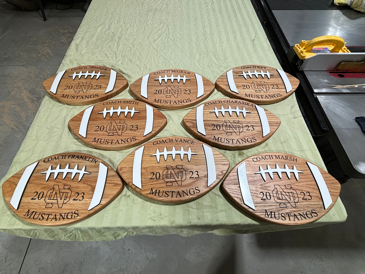 A bunch of wooden football coasters on a table