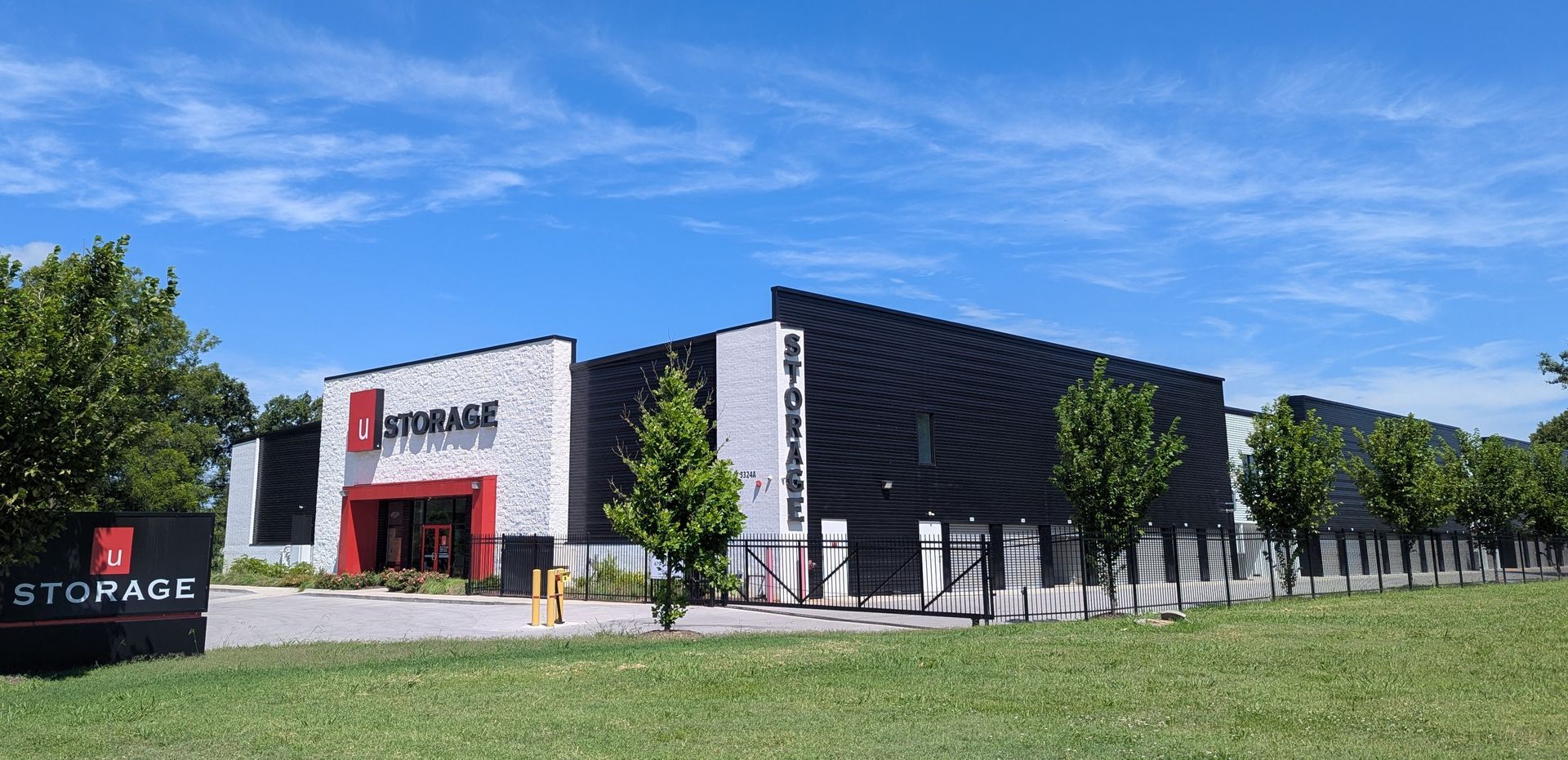 Storage facility with black and white facade under a blue sky.