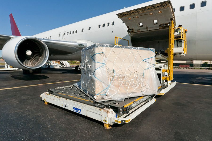 An Airplane Is Being Loaded with Cargo on The Tarmac — Novocastrian Removals & Storage in Cardiff, NSW