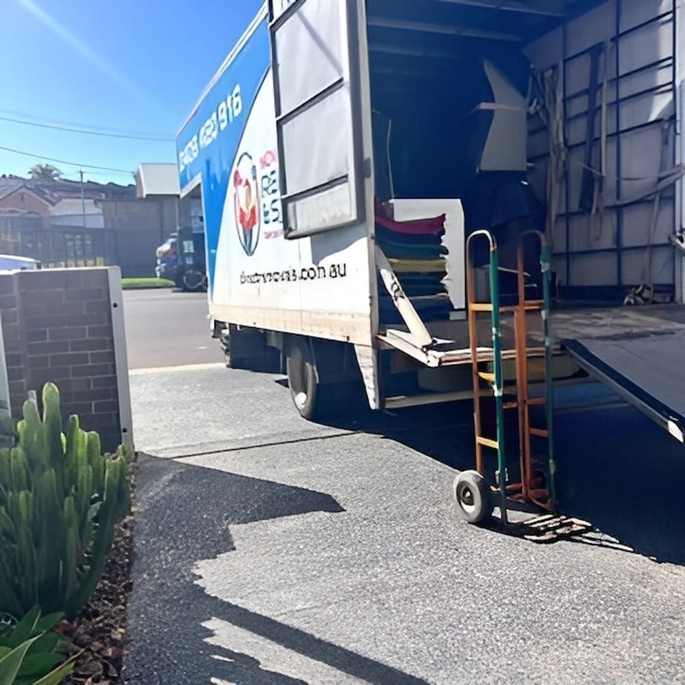 A Moving Truck with A Trolly in Front of It — Novocastrian Removals & Storage in Cardiff, NSW