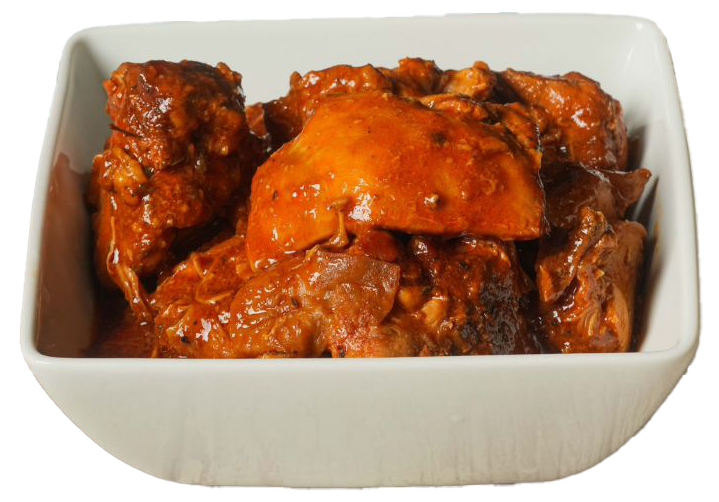 Stewed meat in a white square bowl, coated in a rich brown sauce.