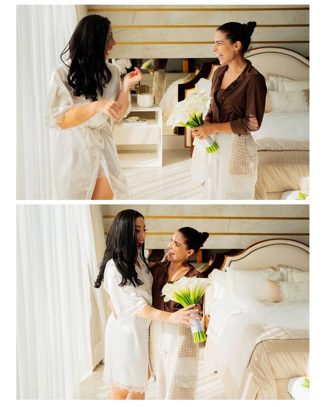 Two people in a bedroom, one in a white robe and the other in a brown top, sharing a bouquet of white calla lilies.