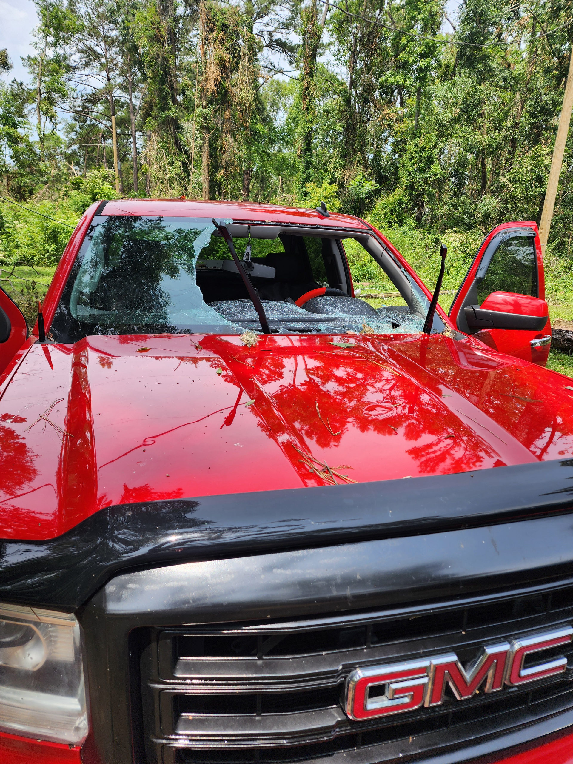 Person using blue suction cups on a windshield. Inside a garage.