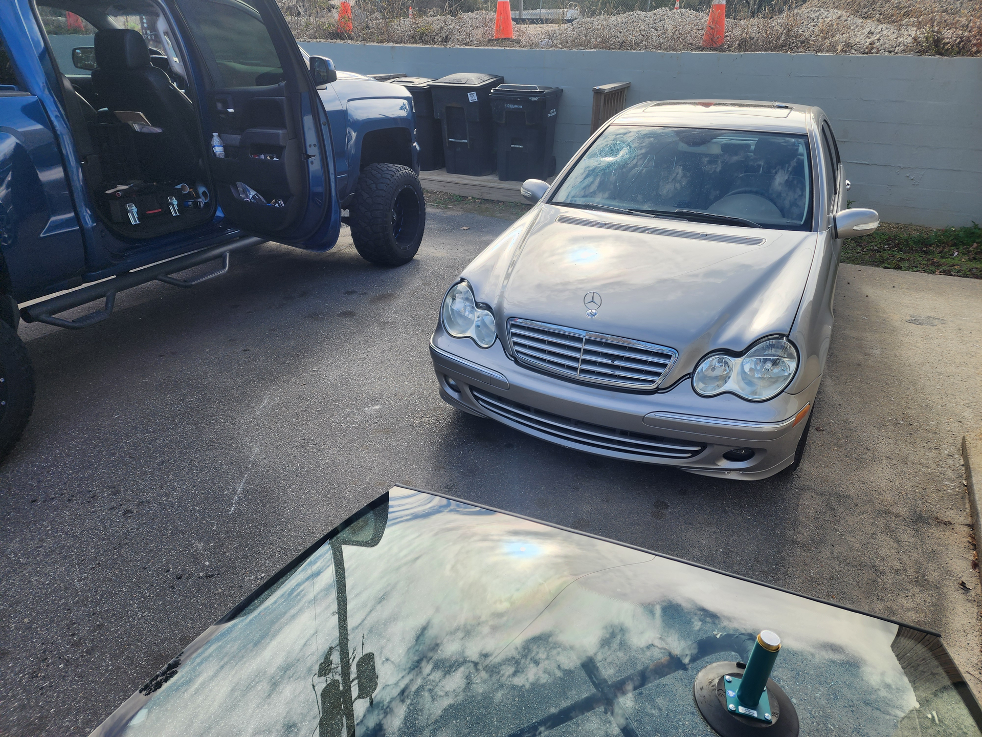 Person using suction cups to install a windshield.