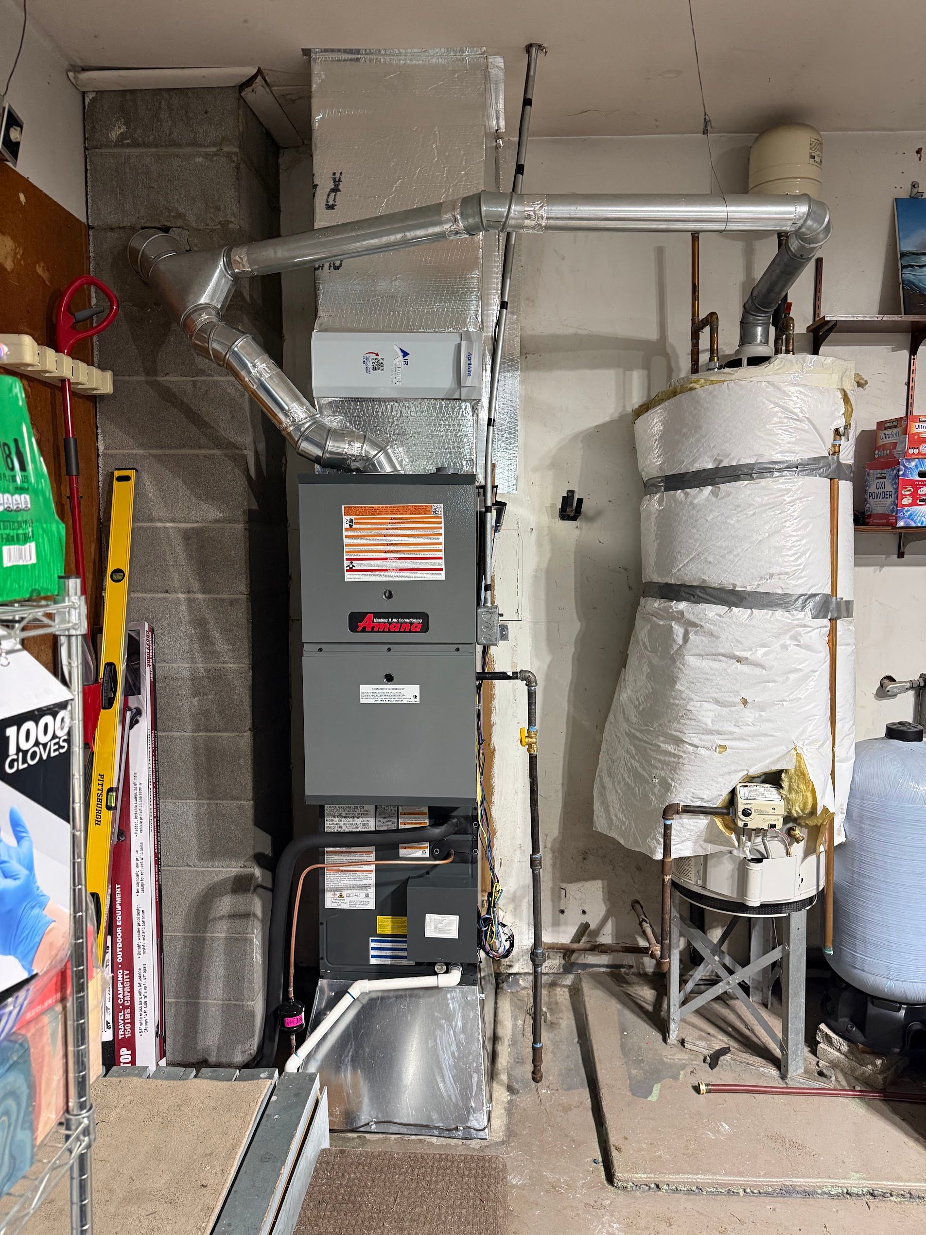 Utility room with HVAC furnace, ductwork, and a large insulated water heater tank.