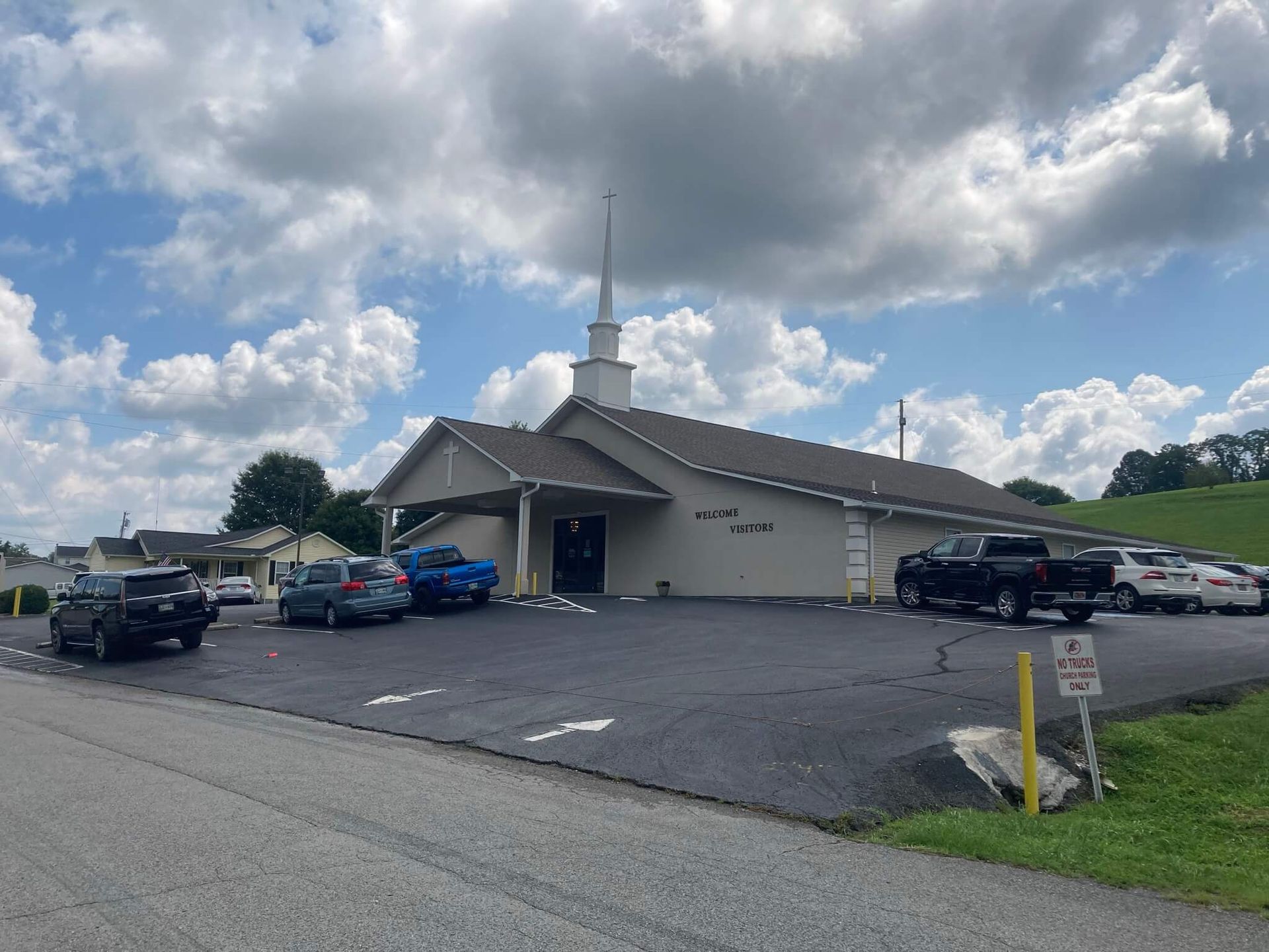 Heritage Baptist church building with vehicles