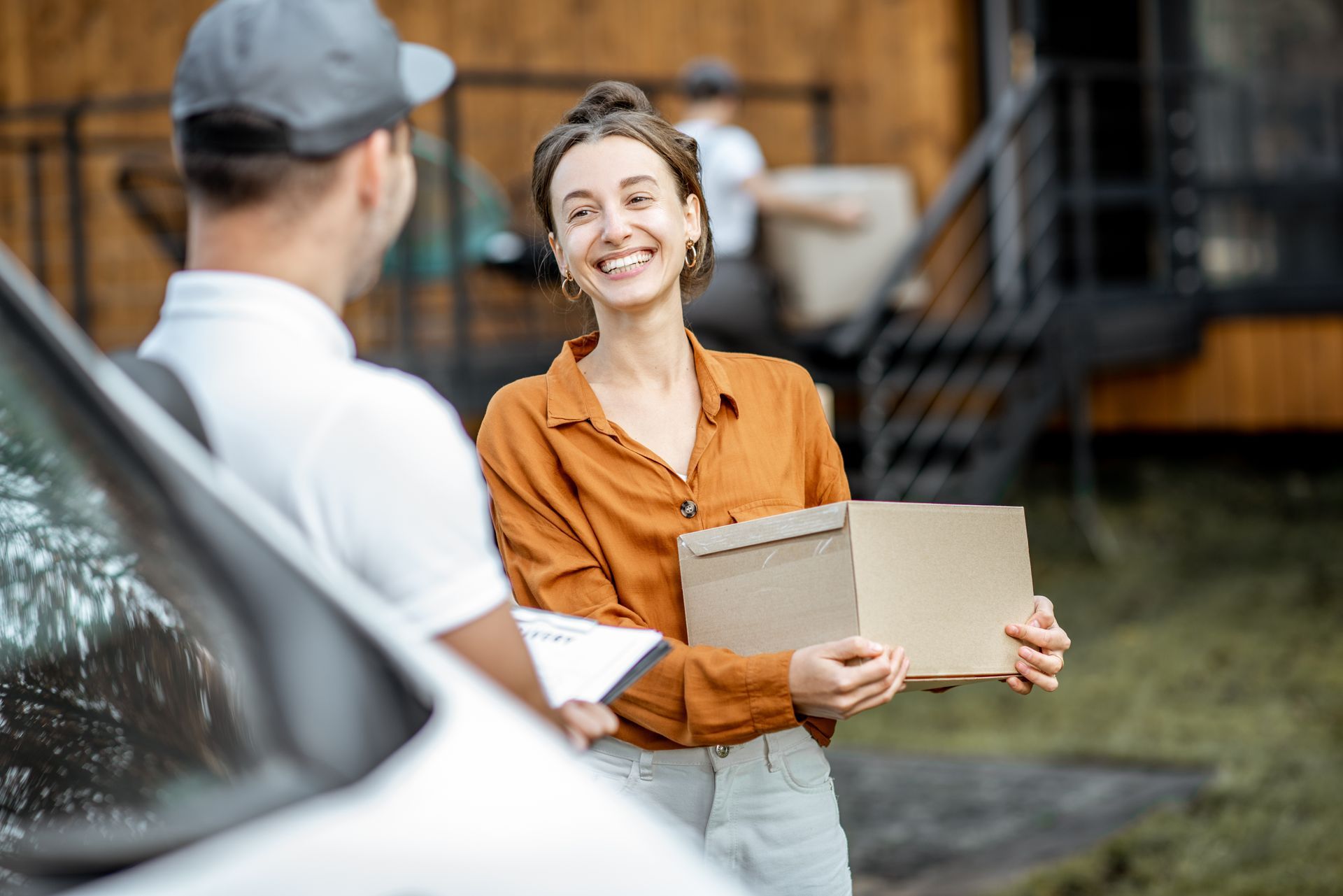 A man is delivering a package to a woman. A man is delivering a package to a woman.