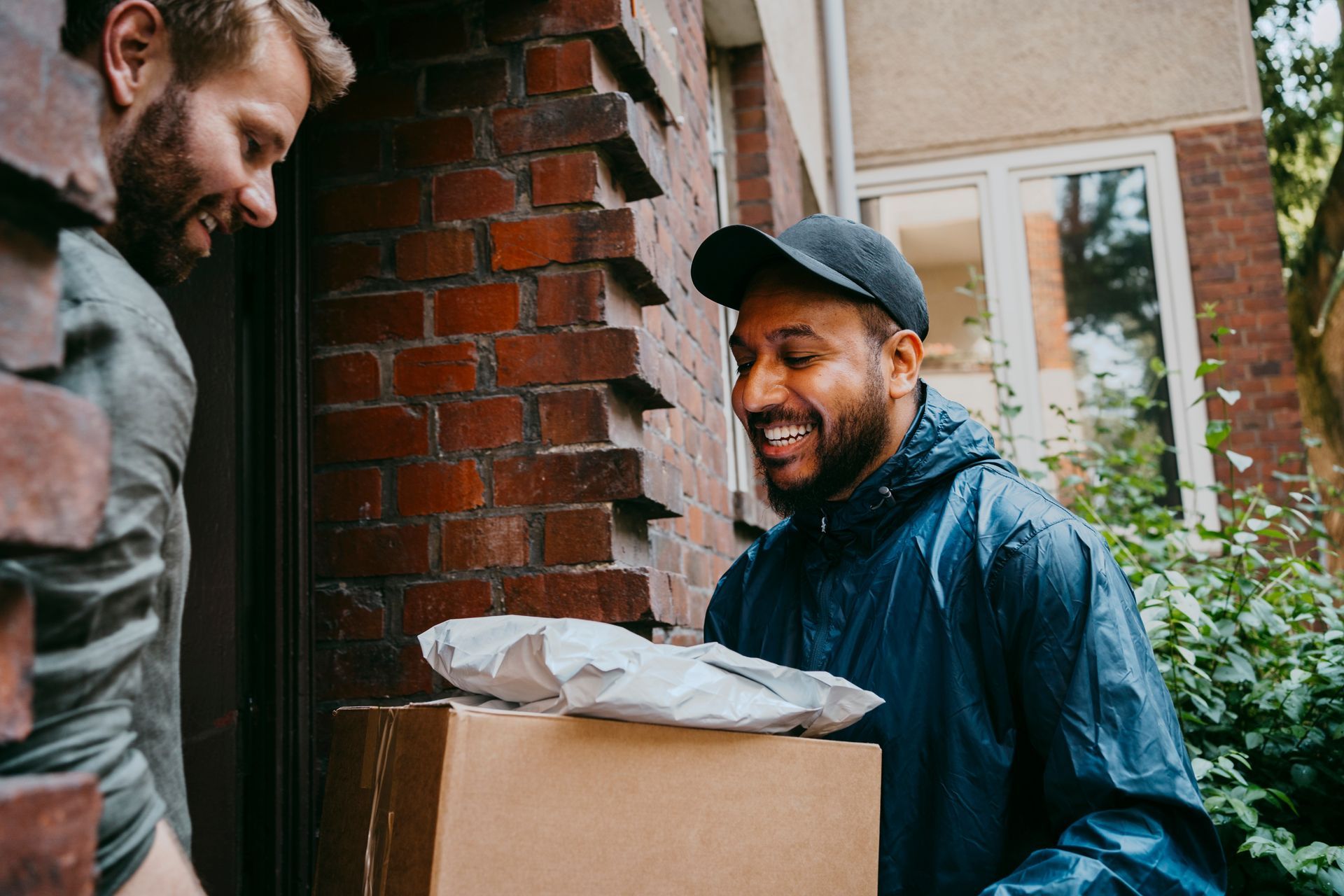 Smiling delivery man has just given a package to a businessman. Smiling delivery man has just given a package to a businessman.