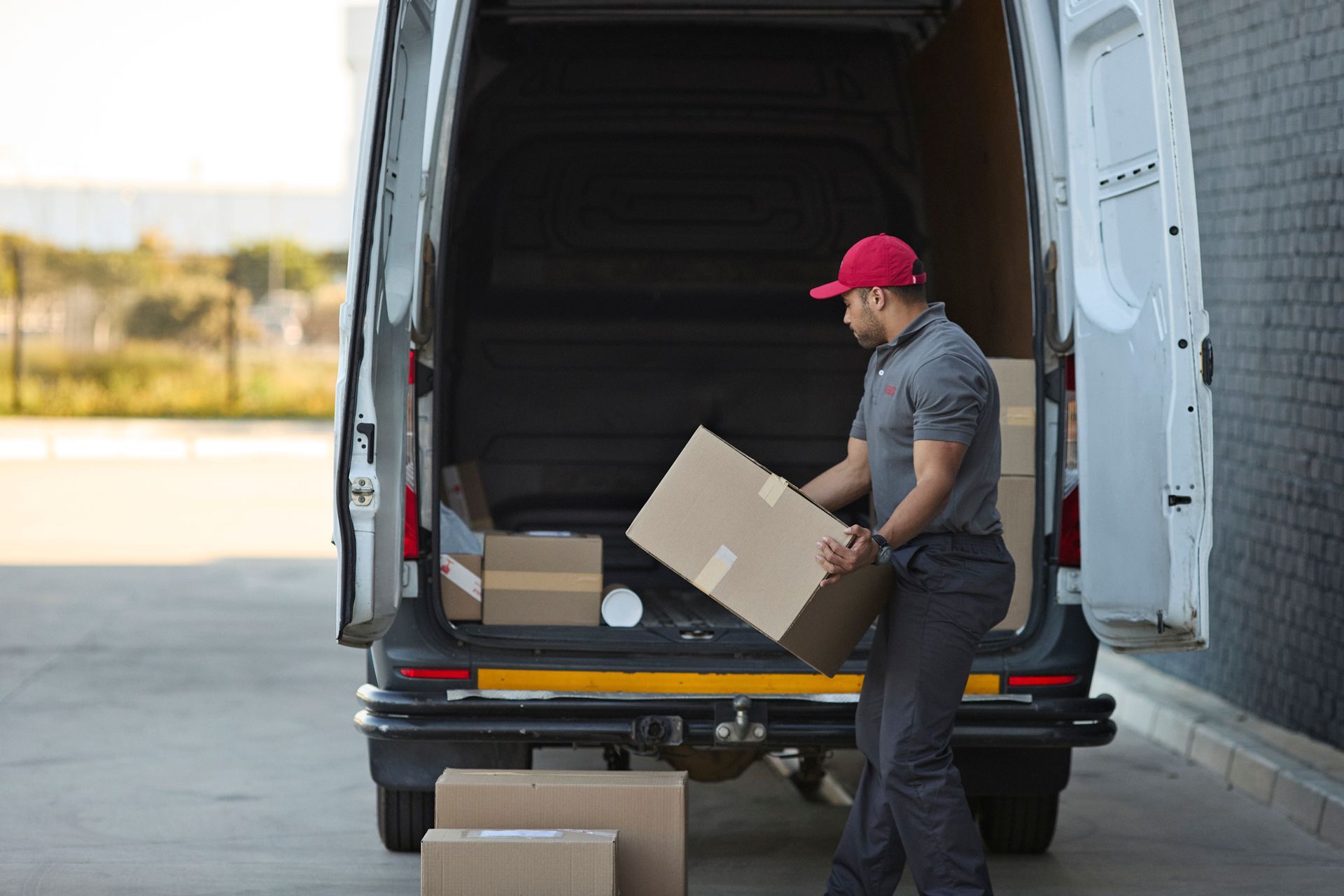 White delivery truck with a clock on top, orange background.