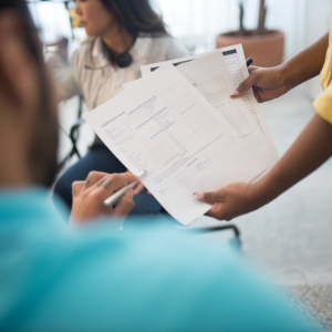 People reviewing printed documents in a casual office setting