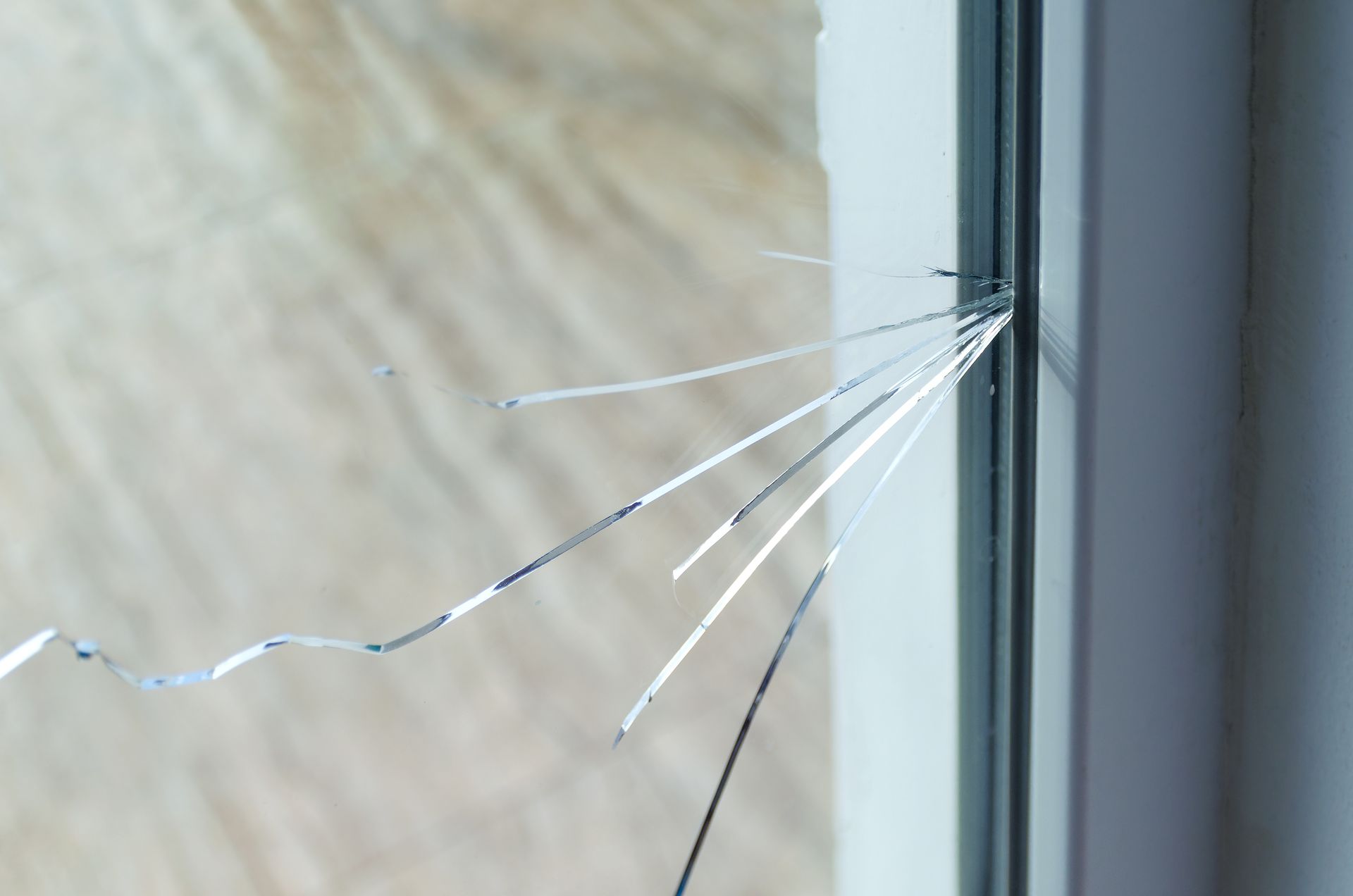 A close-up of a crack on glass at a residential house.