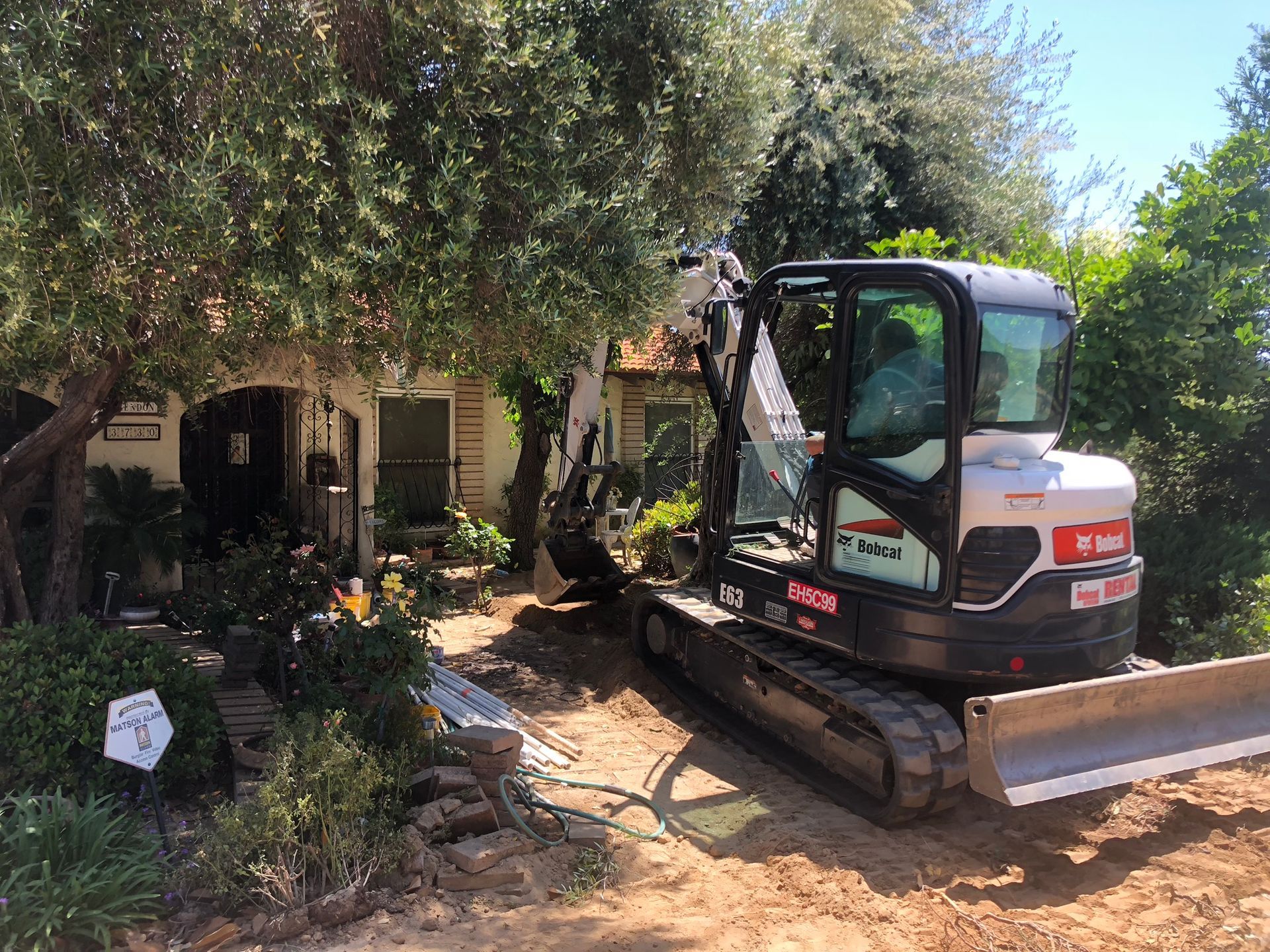 Expert Septic Repair in Tarpey Village: Specialized equipment for tight residential sites. Licensed CA C42 #579423. Big Bore Drilling Inc. (C42 License #579423) performing a septic repair in the tight-access Tarpey Village neighborhood of Fresno County.