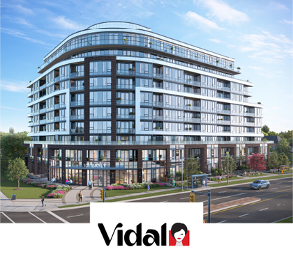 Modern white-and-glass apartment building with curved facade beside a road, with Vidal logo below