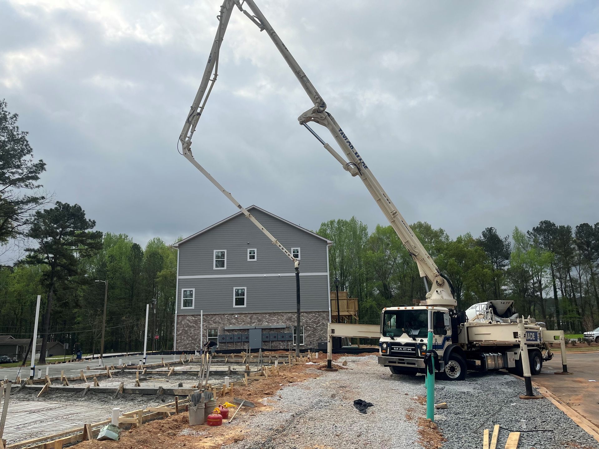 A Concrete Pump Truck is being used to pour Concrete in front of a House under Construction | Tallapoosa, GA | Taylor-Made Pumping