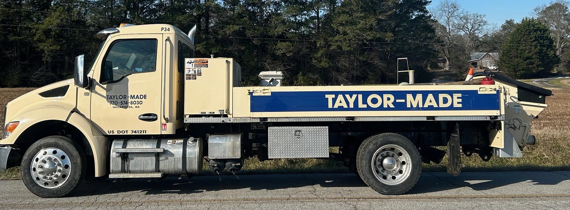 A taylor truck is parked on the side of the road.