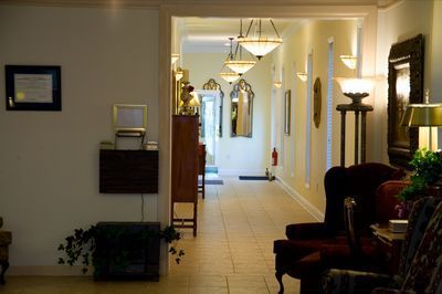 a long hallway with a lot of furniture and lamps