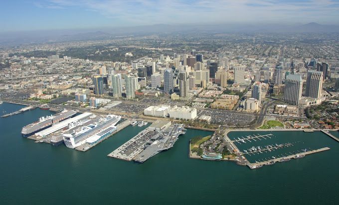 An aerial view of a city with boats docked in the water.