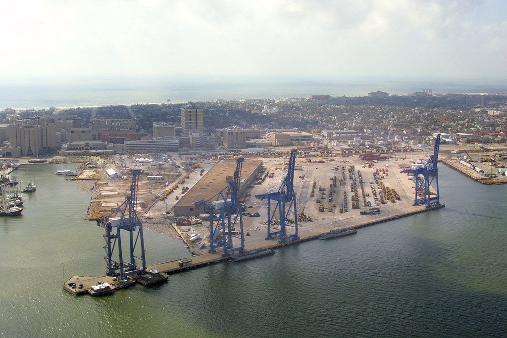 An aerial view of a large body of water with a city in the background
