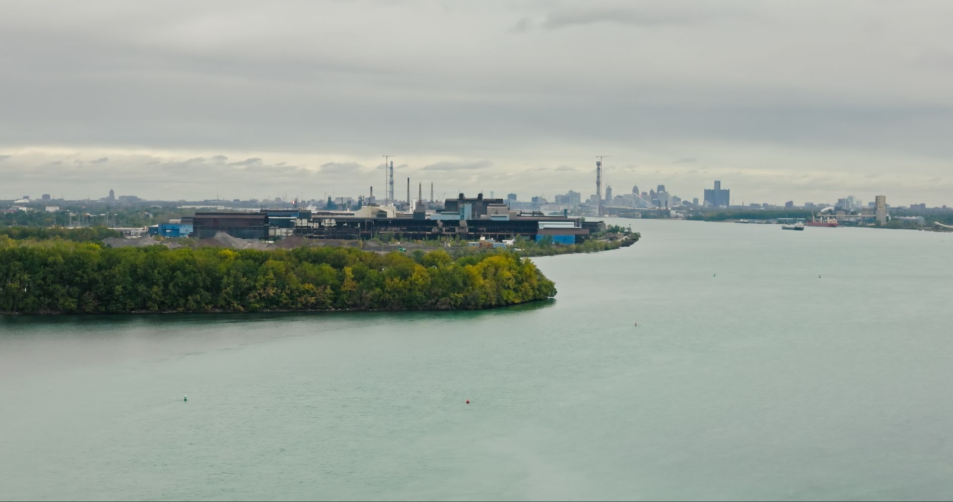 An aerial view of a large body of water with a small island in the middle.