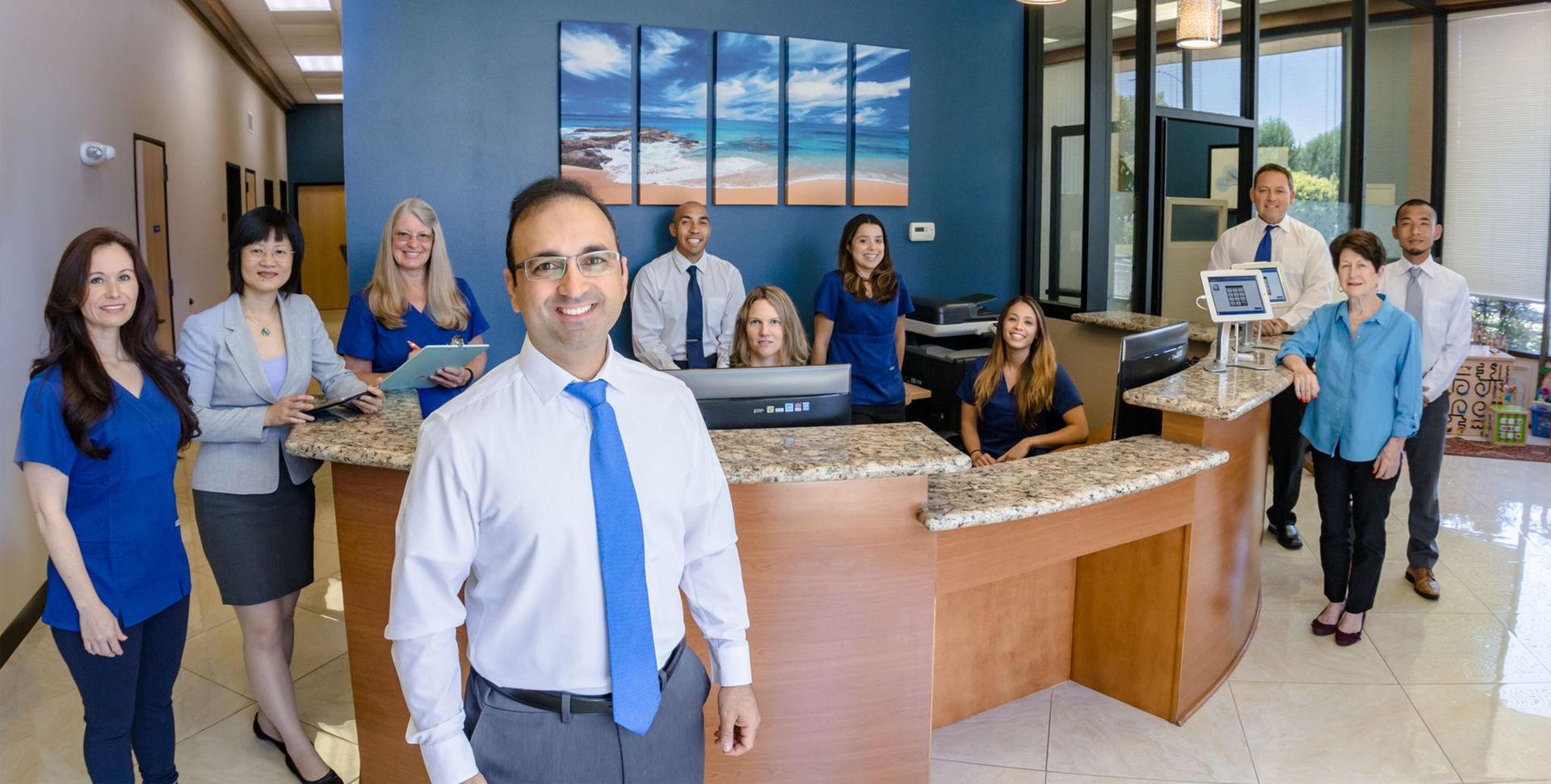 a group of people are posing for a picture in a hospital lobby .