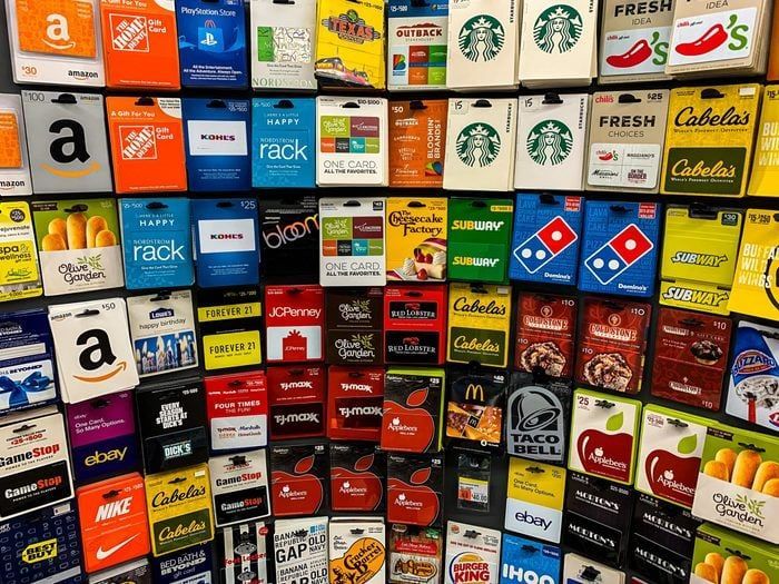 A wall filled with lots of different types of gift cards.