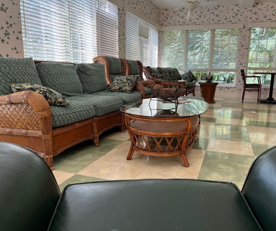 Transitional Care Center living room filled with furniture and a table.