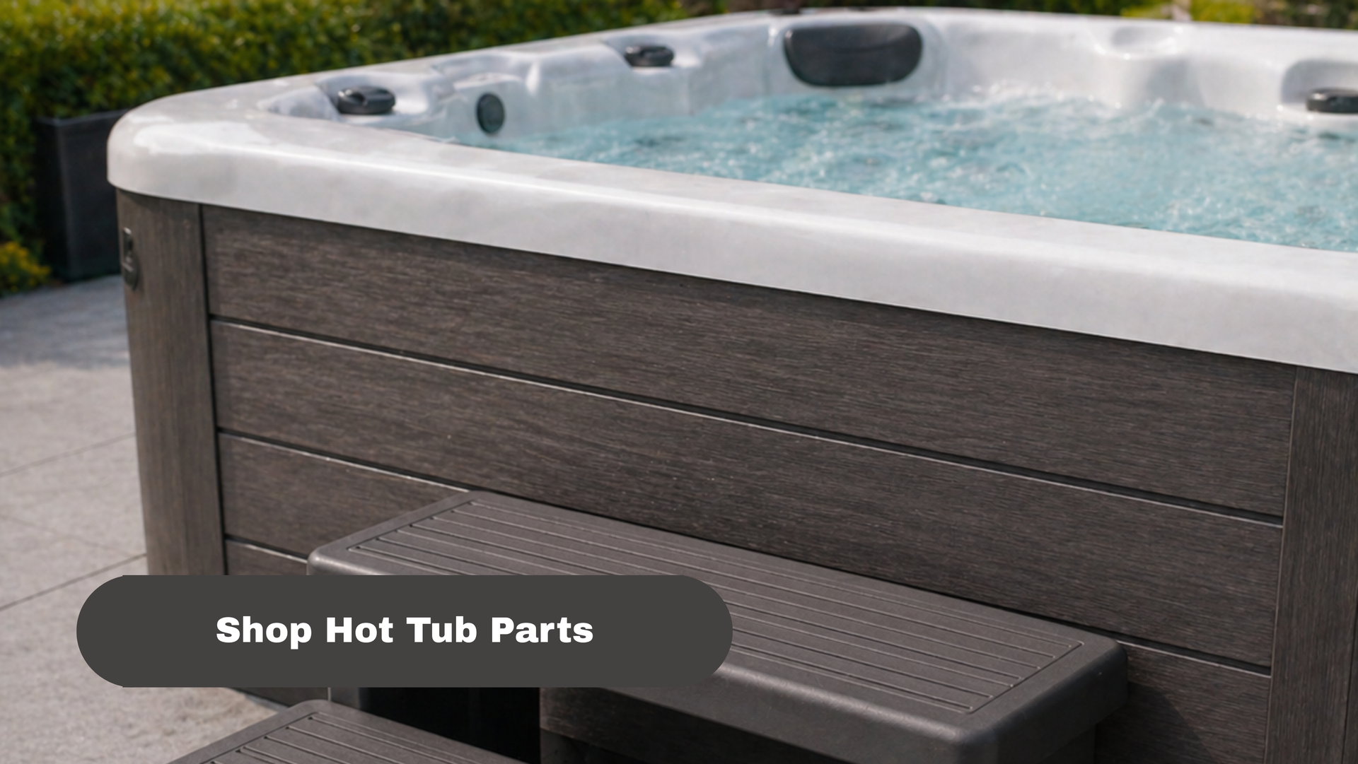 Gray hot tub with water outdoors, featuring a “Shop Hot Tub Parts” button overlay