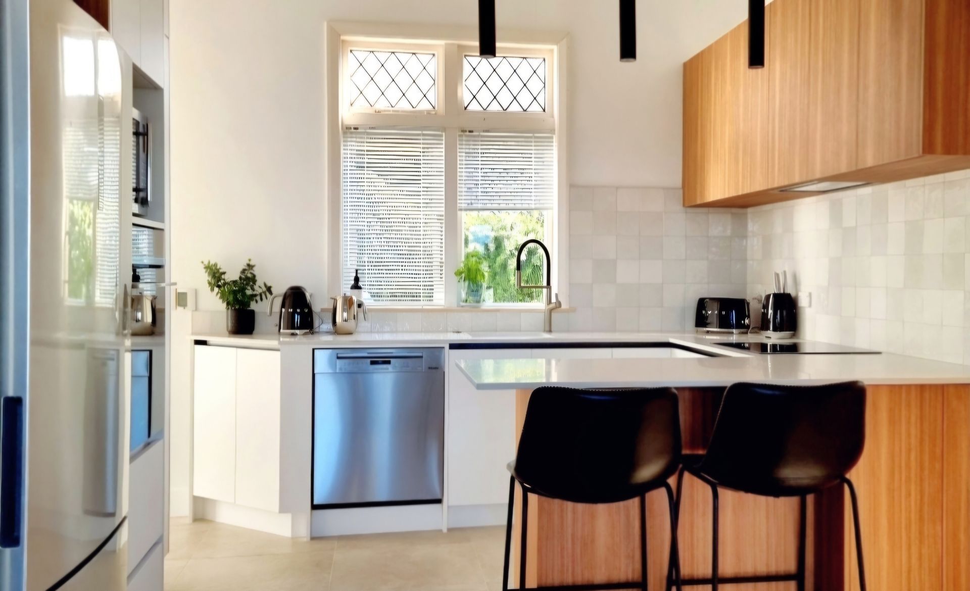 A kitchen with stainless steel appliances and wooden cabinets.