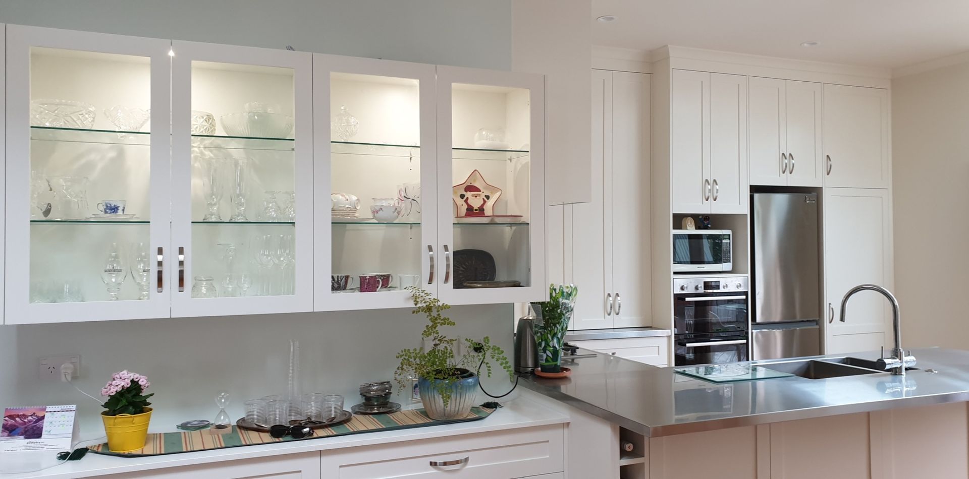 A kitchen with white cabinets and stainless steel appliances