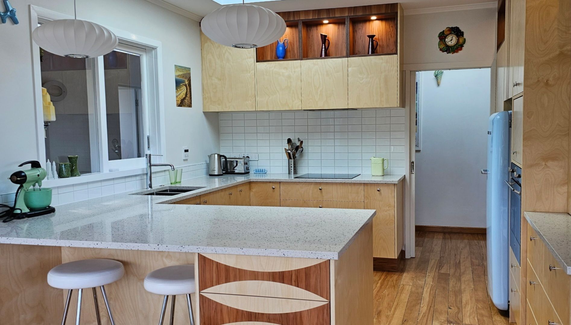 A kitchen with a large island and stools