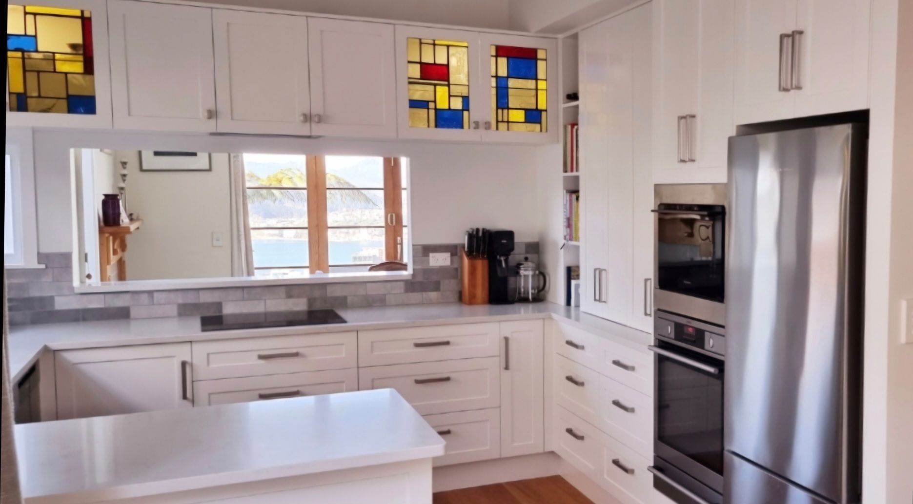 A kitchen with white cabinets and stainless steel appliances