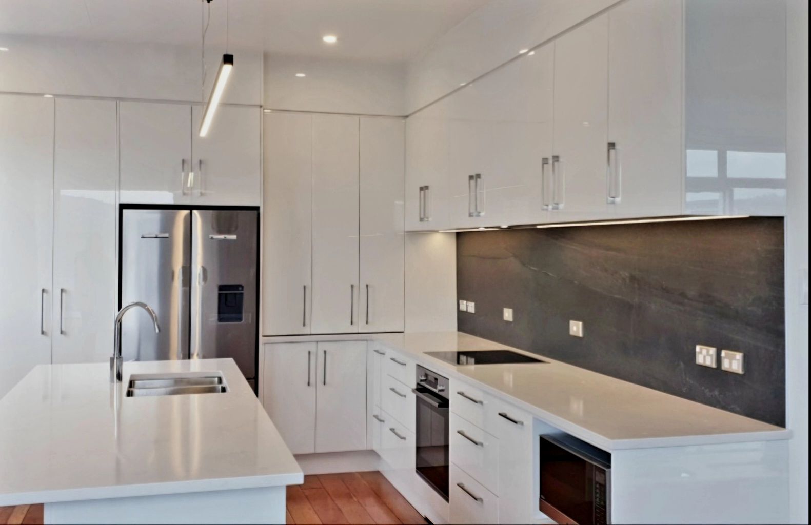 A kitchen with white cabinets and stainless steel appliances