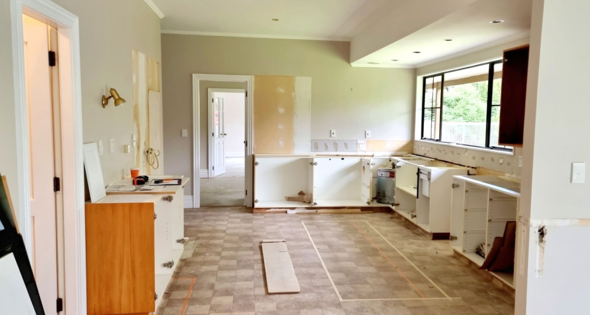 A kitchen under construction with a lot of cabinets and a lot of windows.