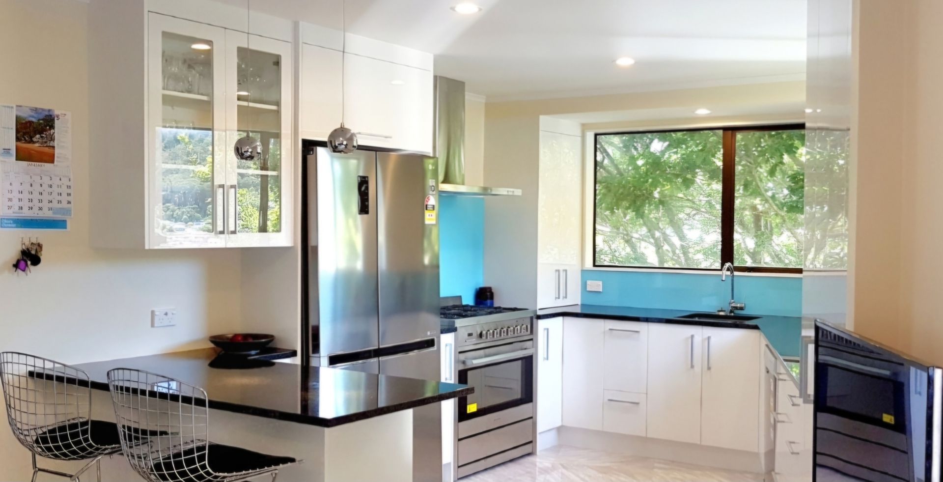 A kitchen with stainless steel appliances and white cabinets